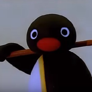 Puffy pink and purple penguins parading on pavement